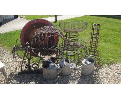 A 30 mph vintage road sign, two hay racks, three galvanised watering cans, a heavy cast iron wall bracket and various other m