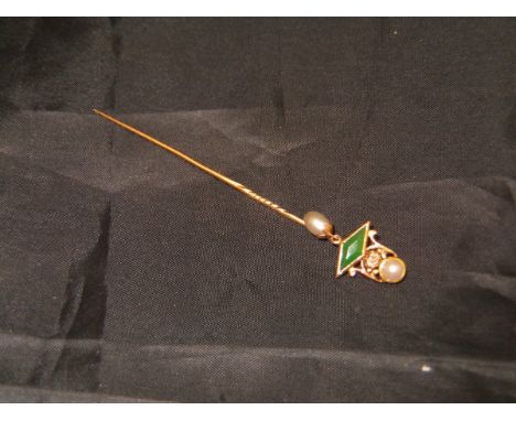 A yellow metal stick pin with diamond emerald and seed pearl decoration