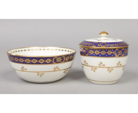 A Caughley Sucrier and cover and matching slop bowl. With wet blue, gilt and enamel borders and with scrolling gilt foliate b