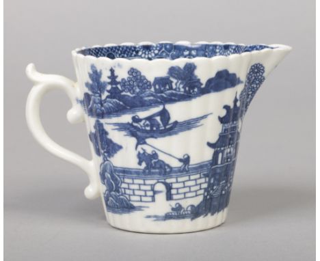 A Caughley cream jug of fluted tapering form and with double scrolling handle. Printed in underglaze blue with the Temple pat