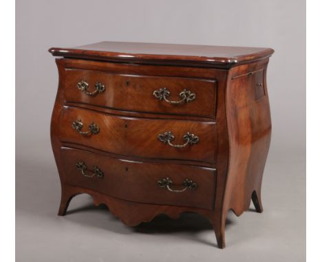 A late 18th / early 19th century kingwood bombe commode. The metamorphic top folding and converting two a two tier shelf, wit