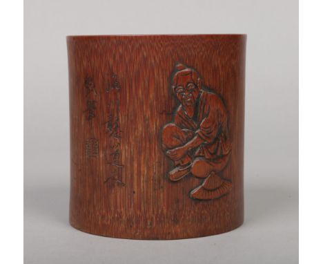 A Chinese bamboo bitong. Carved in light relief with a figure and with incised character inscriptions, 12cm.Condition report 