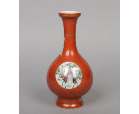 A 19th century Chinese rouge de fer baluster vase. Decorated with gilt key fret borders and flower sprigs and with roundel pa