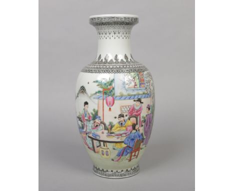 A Chinese Republic period baluster shaped vase. Finely painted in coloured enamels with a Chinese family in an outdoor settin