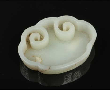 A 19th century Chinese pale celadon jade brush washer. With lobed and scroll border and incised with pine trees and a seal ma