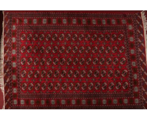 A 19th century Turkish red ground wool carpet, 285cm x 345cm.Condition report intended as a guide only.One patch of repair an