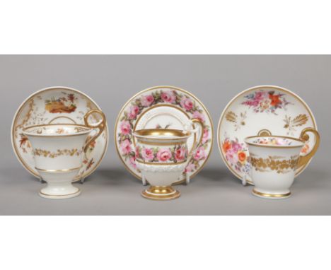 A fine Paris Empire pedestal coffee cup and saucer with scrolling handle having lion mask terminal. With biscuit moulds, gilt