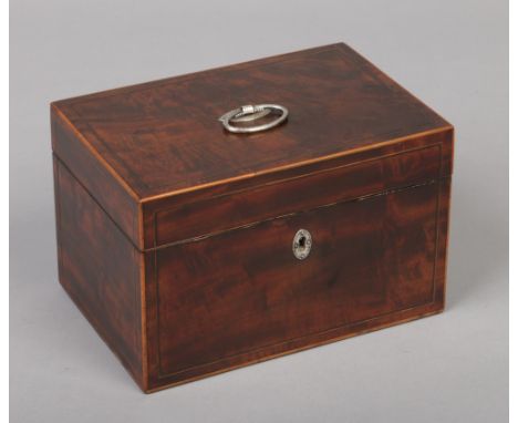 A George III mahogany tea caddy with strung inlay and silver mounts. Fitted with a pair of tea boxes each with ovoid hinged c