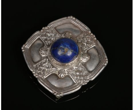 A Scottish white metal brooch / buckle of square Celtic form and set with a large lapis lazuli cabochon, 52mm wide.Condition 