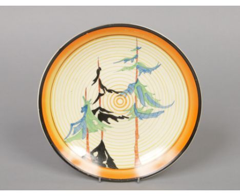 A Wilkinson pottery plate by Clarice Cliff. Decorated with the Pine Grove pattern from the Bizarre range. Printed mark, 23.25
