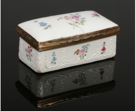 An 18th century enamel and porcelain rectangular snuff box. Painted with flowers and with raised white enamel scrollwork, 8.5