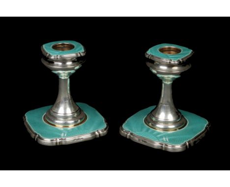 A pair of George V silver dwarf candlesticks by Walker &amp; Hall. Decorated with turquoise guilloche enamel panels. Assayed 