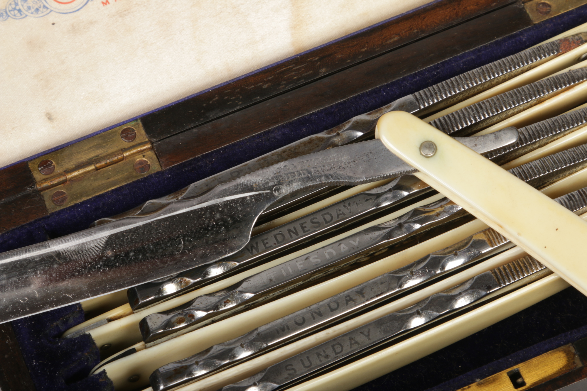 A Wade & Butcher seven day cut throat razor set in brass mounted