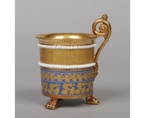 A 19th century Paris three footed cabinet cup with scrolling handle in French Empire style. With beaded moulding, a blue grou