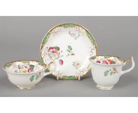 A Rockingham teacup, coffee cup and saucer with single spur handles. With green and gilt borders and enamelled with flowers. 