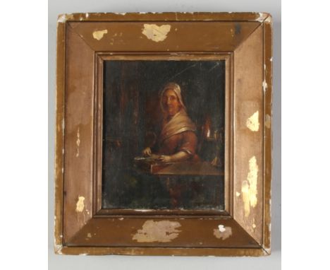 An early 19th century small gilt framed oil on panel. Genre interior scene with an old woman sewing by lamp light, 12cm x 10c