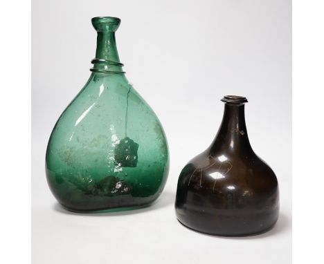 An 18th century black glass mallet form bottle with neck rim, 17cm and an 18th century Persian green glass flask, 27cm Dark b