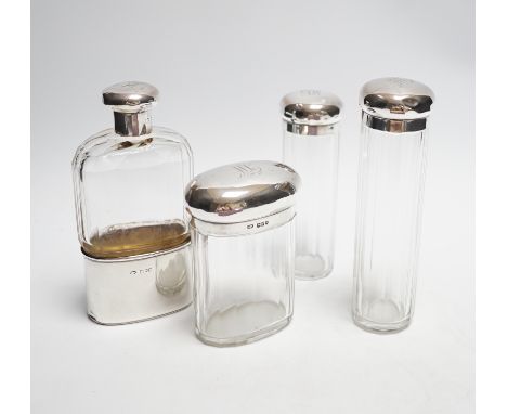 A George V silver mounted glass hip flask, London, 1912, 15.2cm, together with three matching silver mounted glass toilet jar