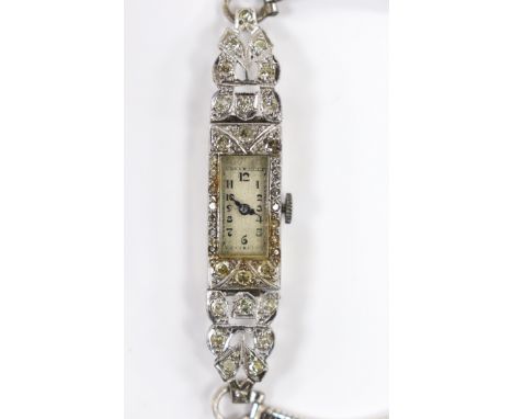 A lady's white metal stamped (All Platinum) and diamond cluster set manual wind cocktail watch, on a 9ct white gold bracelet,