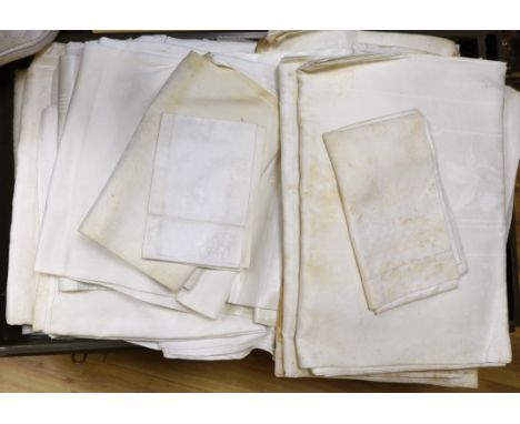 A tin trunk containing a large quantity of 19th and 20th century linen damask table cloths, together with a smaller quantity 