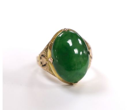 A Chinese 14k yellow metal and oval cabochon jade set ring, size I, gross weight 5.4 grams.