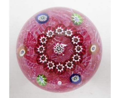 A Paul Ysart millefiori garland glass paperweight, Harland period, ‘H’ cane, with scrambled pink latticino ground, 6.5cm Good
