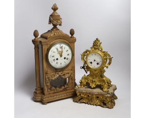 A late 19th century French carved blonde wood mantel clock and similar gilt metal mantel clock. Tallest 45cm
