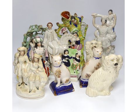 Seven Staffordshire flat backs, including a gentleman on horse back, two seated lovers, a similar pair of King Charles Spanie