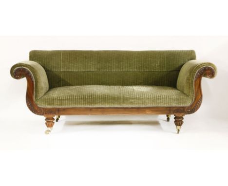 A Regency mahogany scroll end settee,with carved leaf and moulded panel decoration, on turned legs and brass castors, with gr