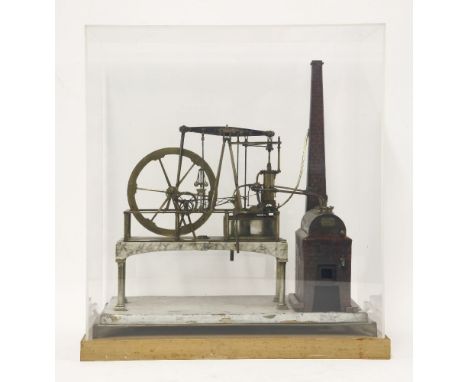 A brass stationary steam engine,with imitation brick boiler and chimney with a beam pump with fly wheel, bearing a plaque ins