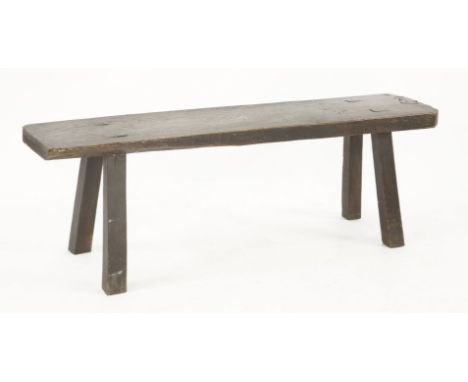 An oak bench,19th century, with a solid single piece top on square legs,133cm wide30.5cm deep46cm high