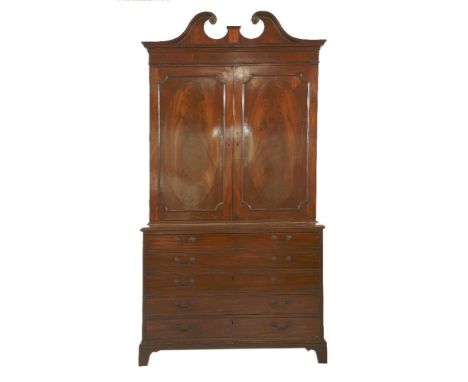 A George III mahogany 'Estate' secretaire bookcase, in the manner of Gillows of Lancaster, the broken swan neck pediment with