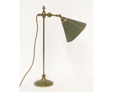An adjustable brass table lamp,late 19th/early 20th century, with the original fabric covered shade on a weighted base,49cm h