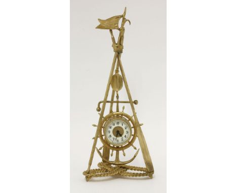 A gilt metal nautical-themed clock, the timepiece in a ship's wheel and anchor mount, suspended from a pulley to three oars, 