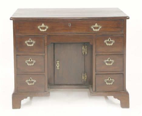 A George II mahogany kneehole desk,with eight drawers around a kneehole with a frieze drawer and door,92cm wide56.5cm deep73c