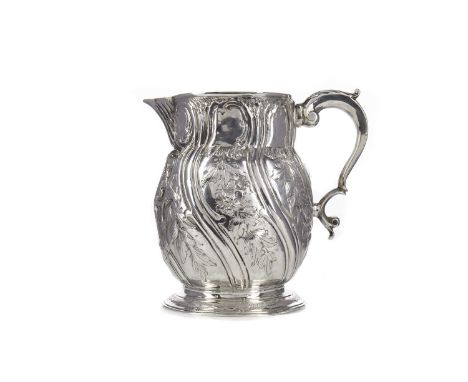 GEORGE II SILVER BEER JUG,maker Fuller White, London 1739 (second version of date letter used), repousse decorated in the Roc