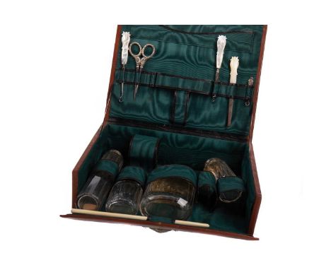 VICTORIAN TRAVELLING DRESSING TABLE SET,circa 1900, contained in a leather case with handle, the hinged cover opening to reve