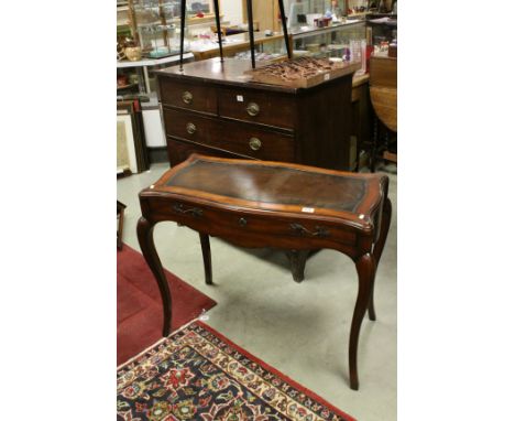 Theodore Alexander Mahogany Effect Dressing Table, the shaped leather inset top sliding to reveal a hinged mirror and jewelle