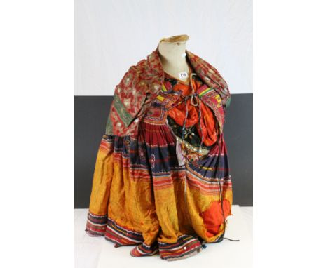 Vintage Torso Mannequin with various ethnic style clothes