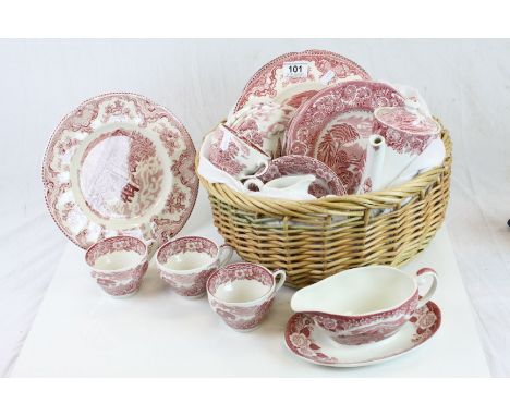 Wicker basket containing a part set of Johnson Brothers ceramic dinnerware in "Old Britain Castles" pattern