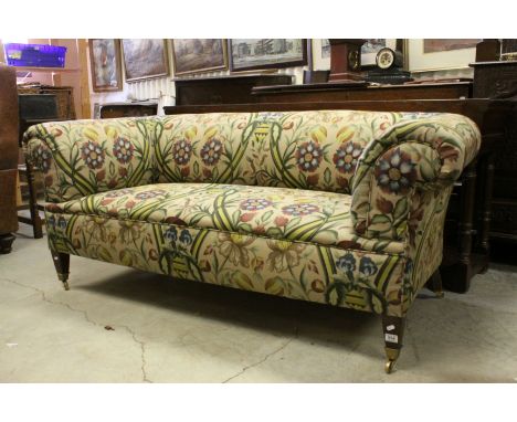 19th century Scroll Arm Chesterfield Style Sofa, upholstered in floral fabric of muted tones, raised on tapering square legs 