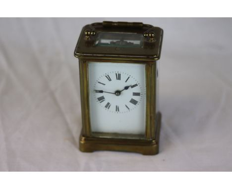 French brass carriage clock, white enamel dial with black Roman numerals and black poker hands, height approximately 11cm 
