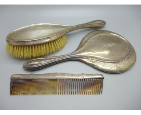 A hallmarked silver brush, mirror and comb 