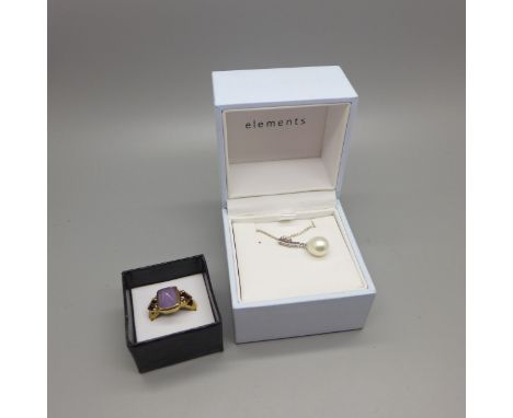 A silver ring, N, and a silver mounted pendant and chain 