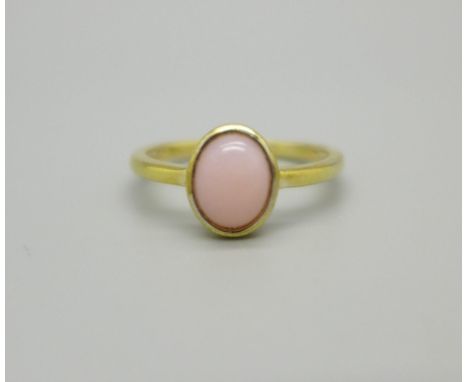 A silver gilt, pink coral solitaire ring, O 