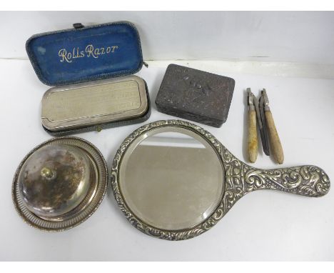 A plated hand mirror, a razor set, curling tongs, a metal box and a silver plated covered dish 