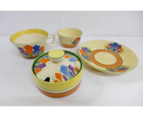 A Clarice Cliff cup, a Crocus Bizarre bowl and saucer and an unmarked preserve pot 