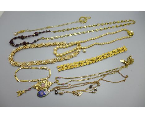 A collection of gold plated jewellery including faux pearls with plated clasp, a mariner link chain with garnet beads, a gold