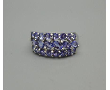 A 9ct white gold ring set with twenty-two tanzanite stones, 3.7g, P 