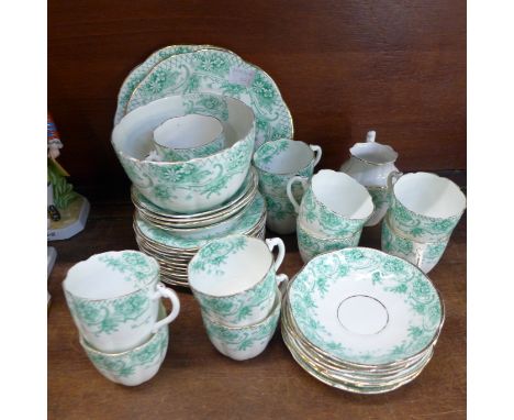 A circa 1900 tea service, eleven cups, eleven saucers, eleven side plates, cream, sugar and two sandwich plates 